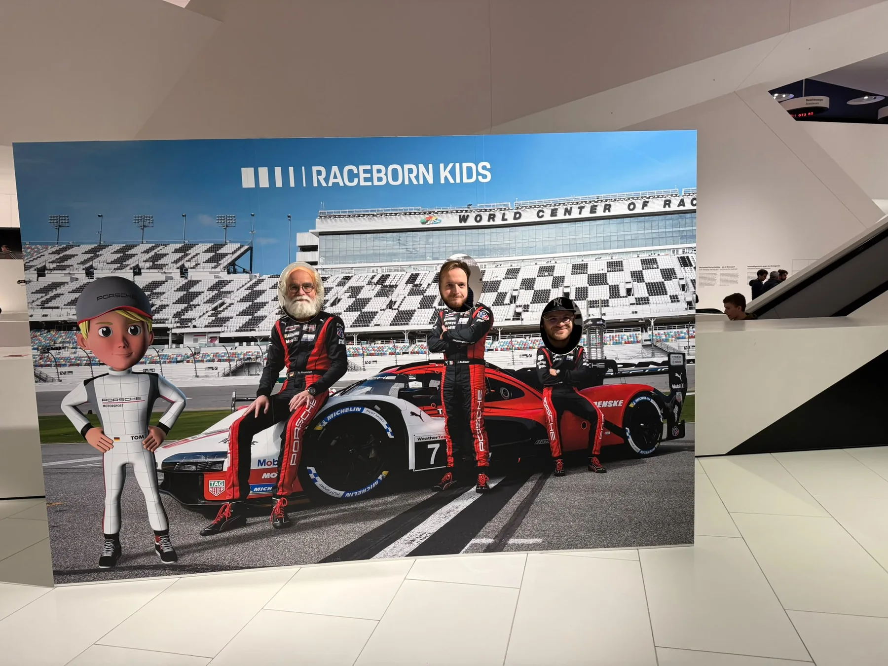Mitglieder des Plauschlagers an einer Fotowand im Porsche-Museum